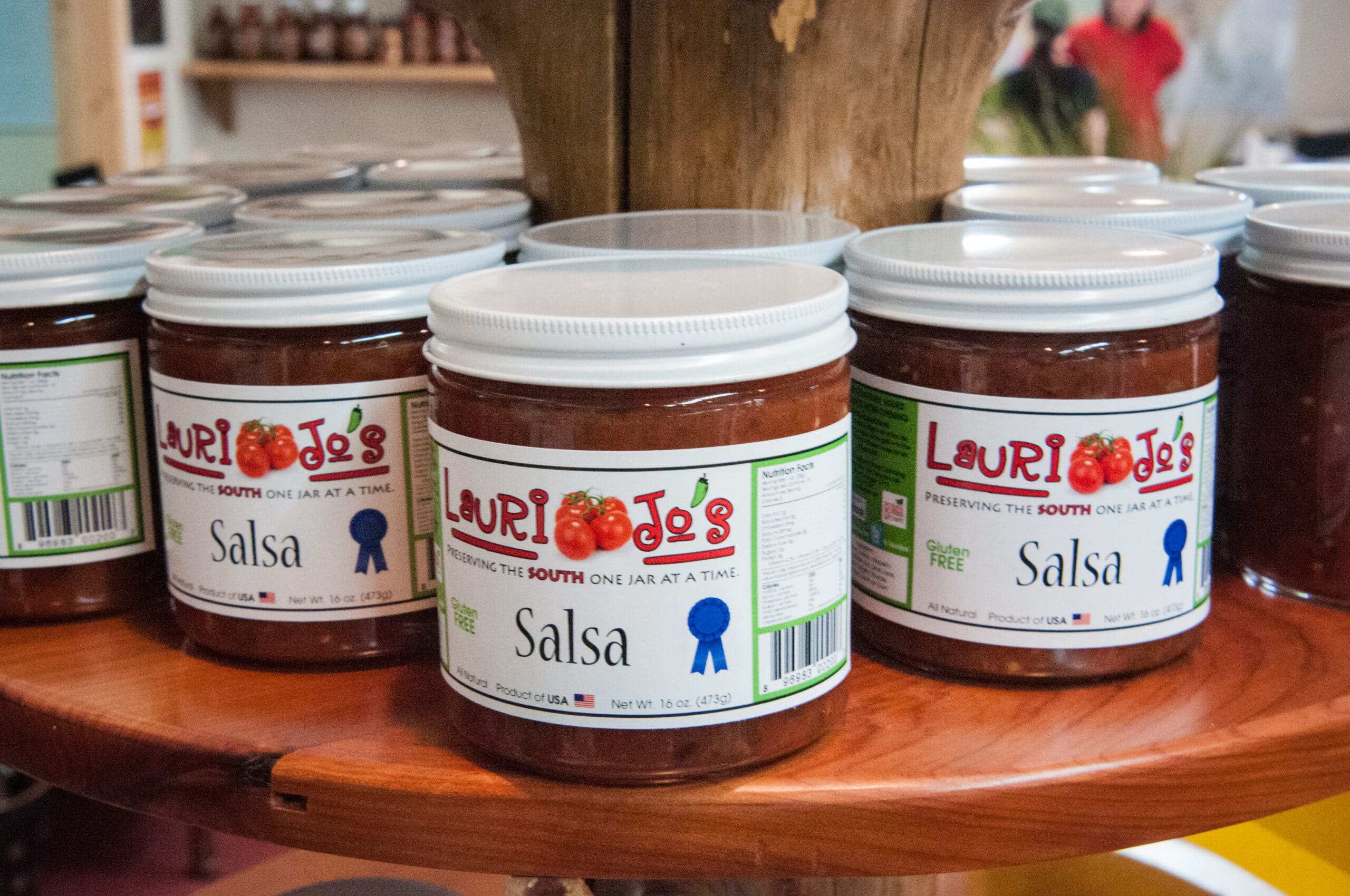 labeled jars of salsa sit on a table