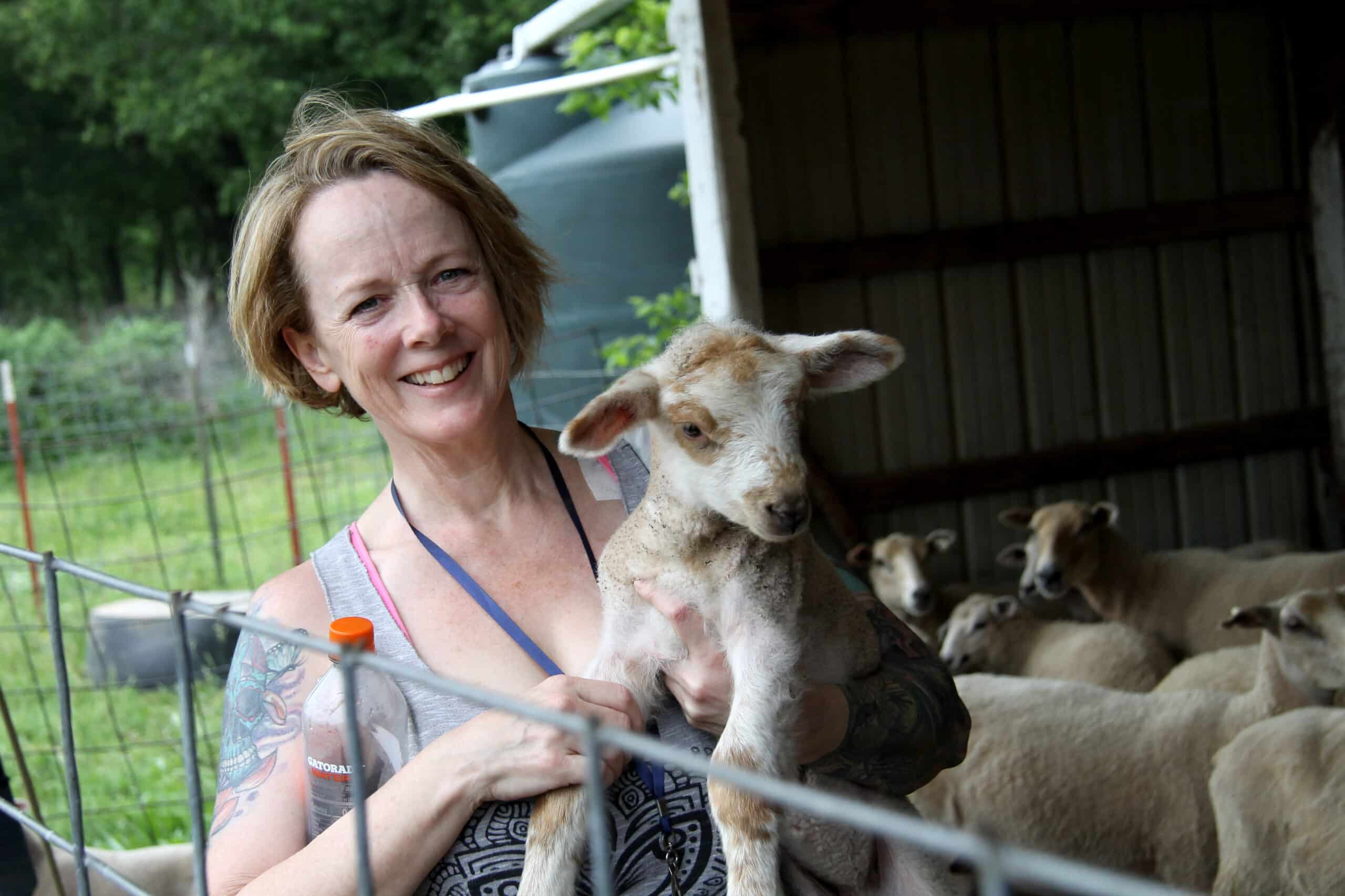 woman holding a lamb