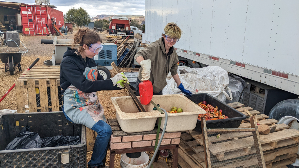 New Earth Project staff grind cafeteria food waste for biochar.