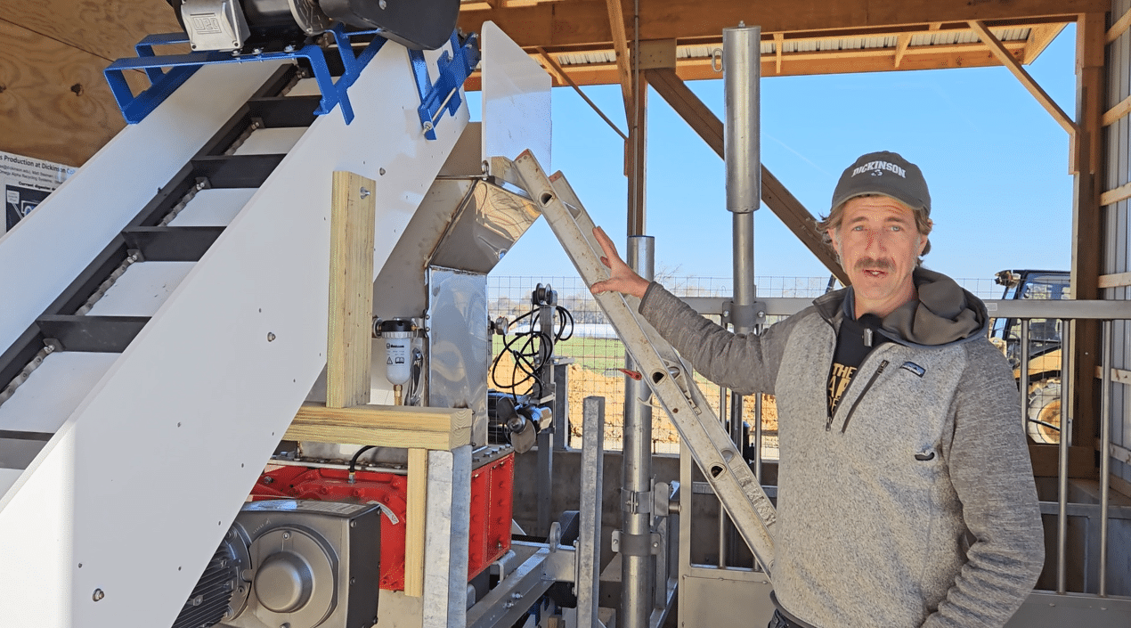Matt Steiman explaining how an industrial grinder works to break down up to 3 tons of food waste a day so it can be pumped to the digester tank