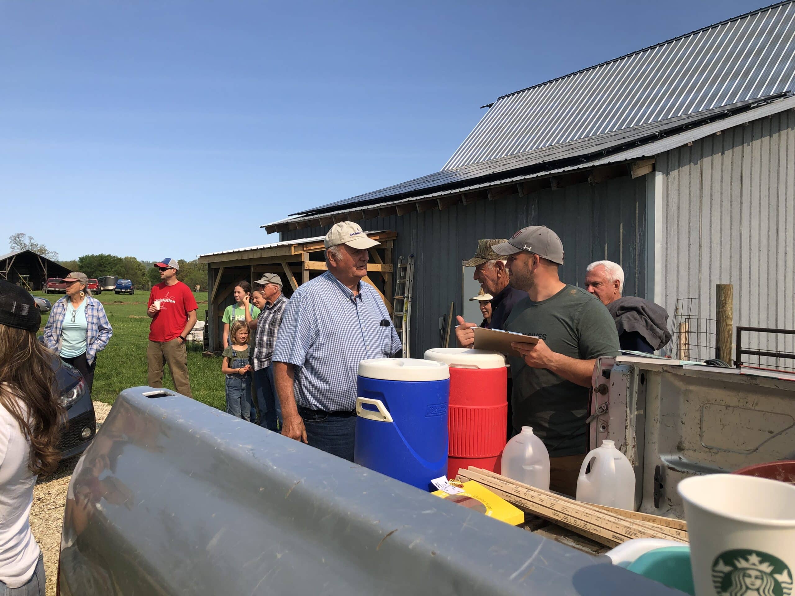 Farmers mingle and get refreshments before the pasture walk begins. A truck makes a fine table. 