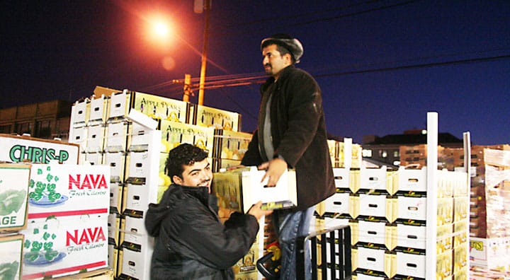 two men loading docks at a terminal market