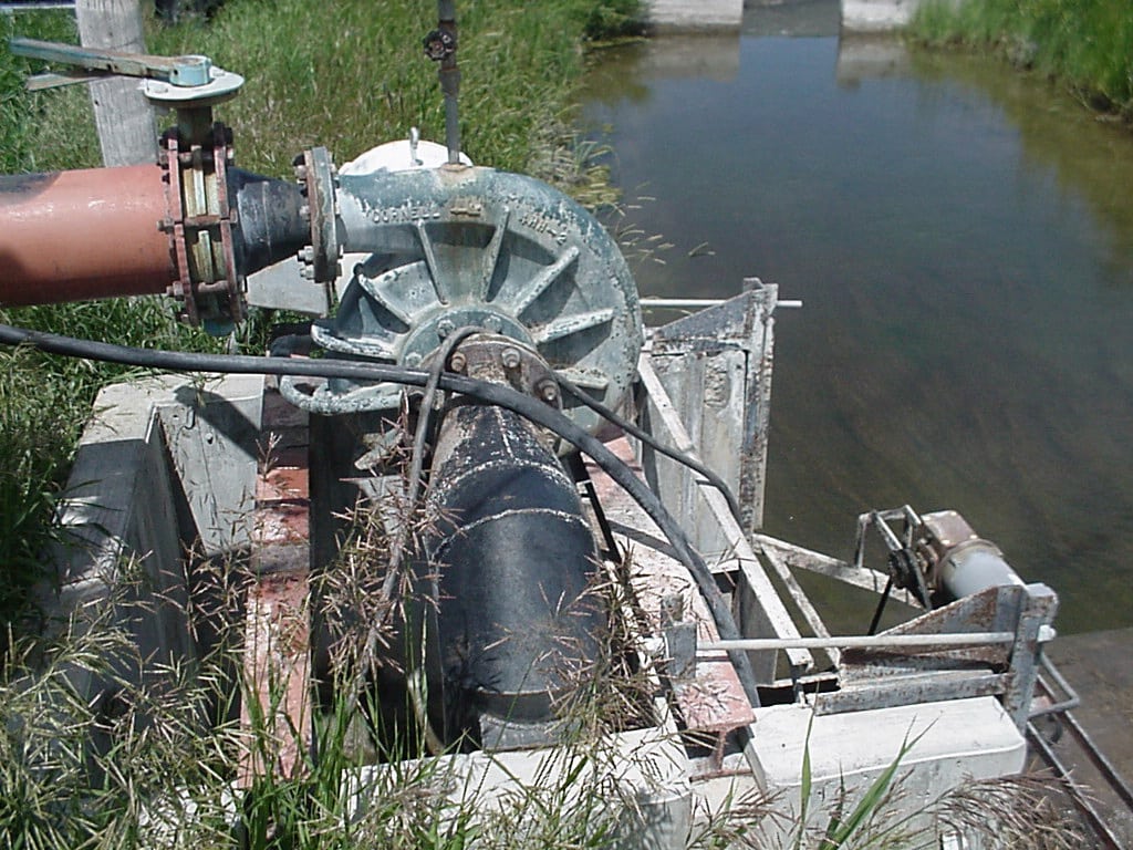 closeup of a pump and irrigation ditch