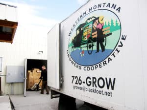 employee loads product onto WMCG delivery truck