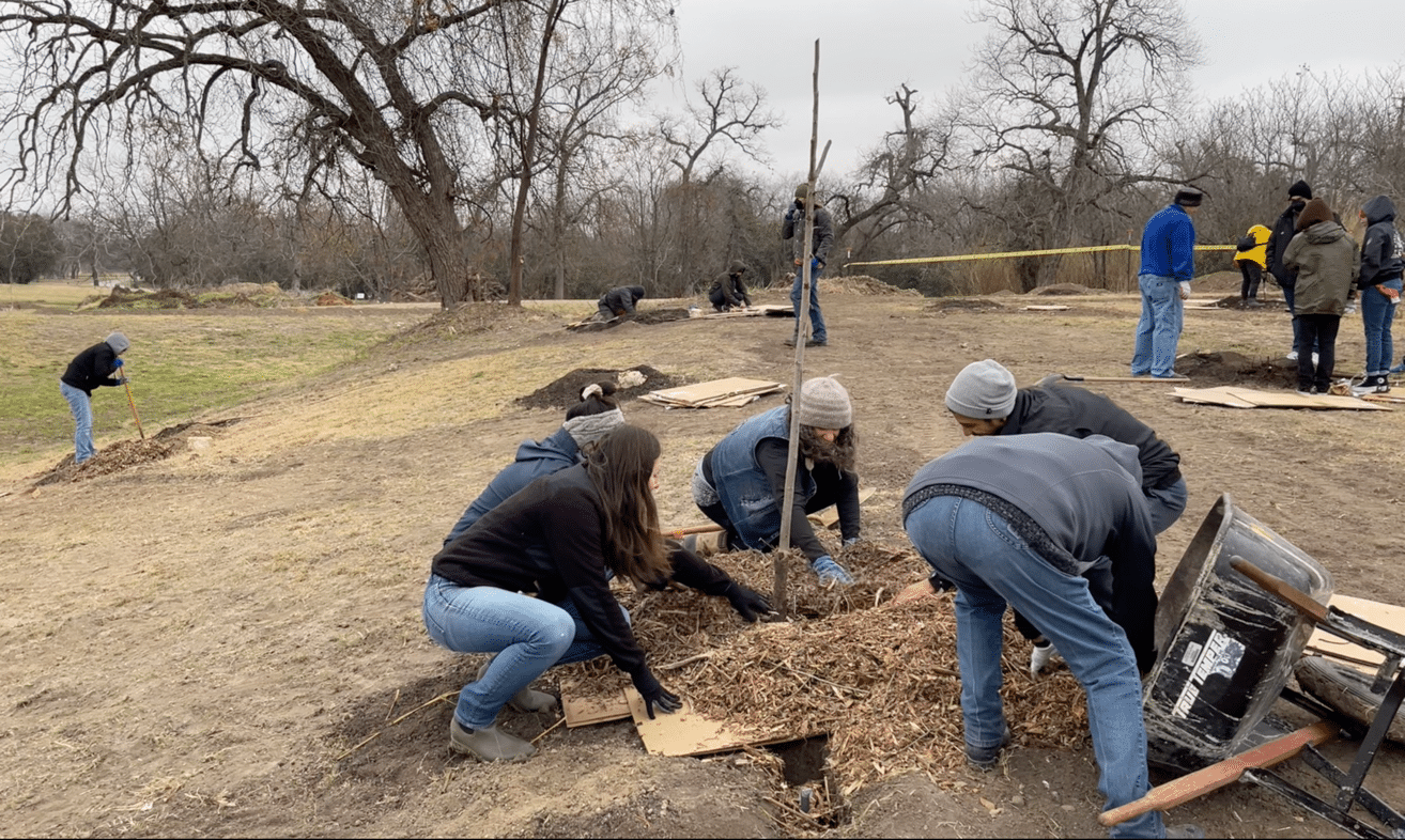 Volunteers plant native pecan trees at the Tamōx Talōm Food Forest. 