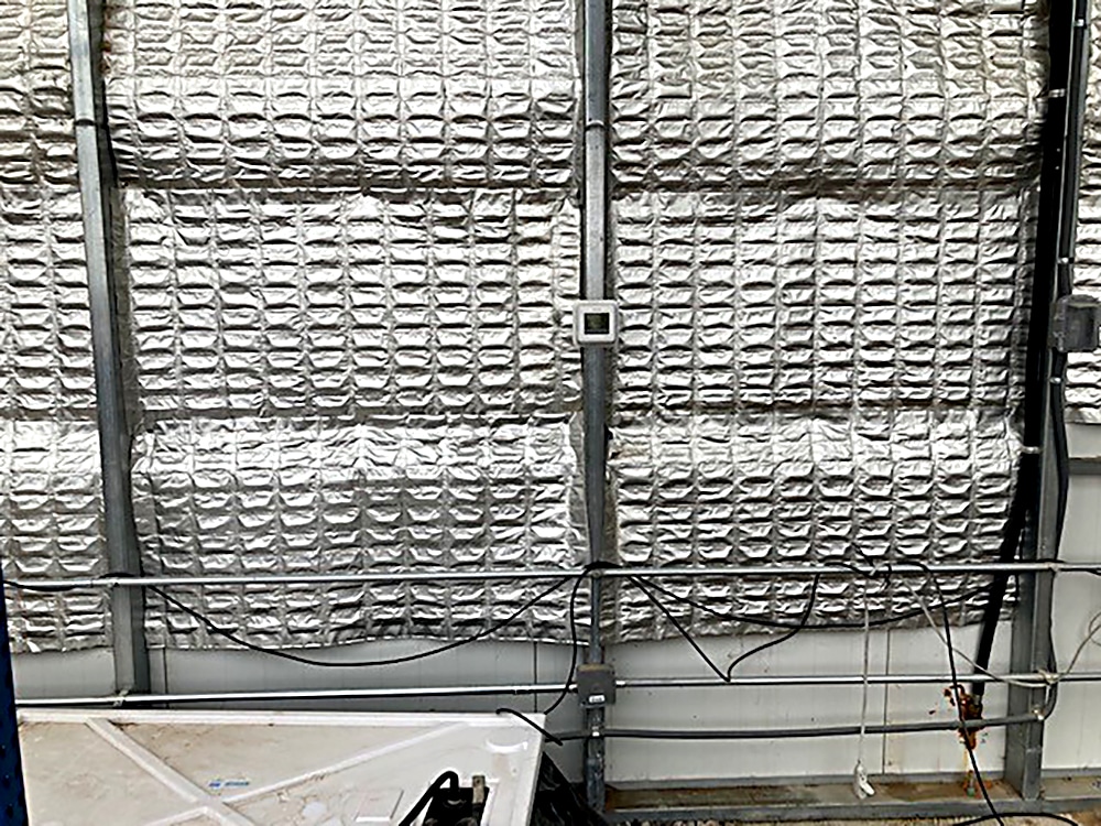 The phase change material shown here, installed on the back wall of a solargreenhouse, is at least five times more efficient at capturing and releasing heat than traditional thermal-mass materials. 