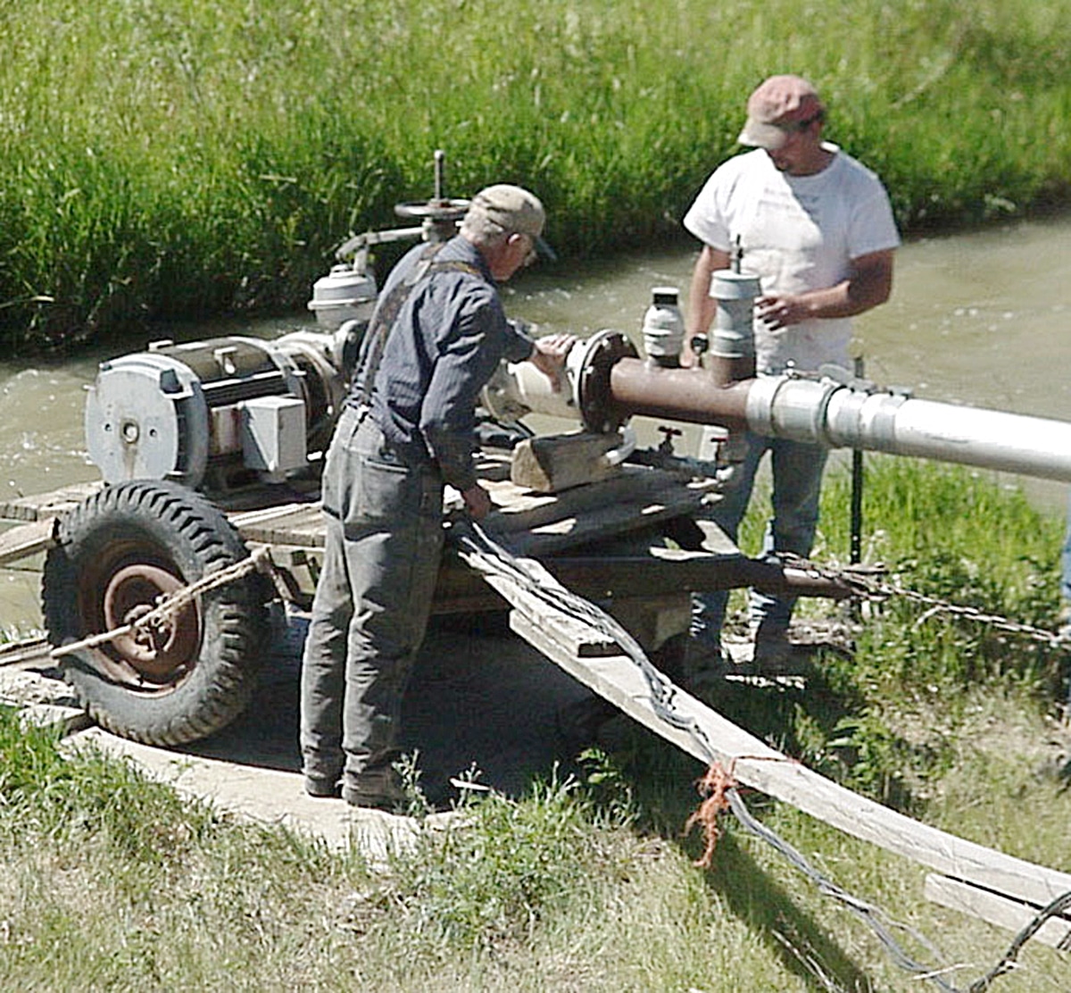 men working on a pump