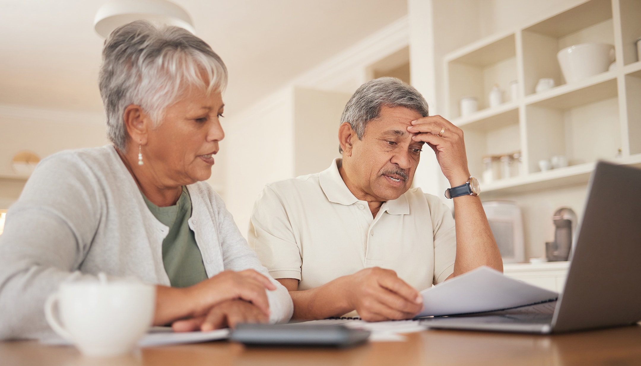 People looking at bills with worried expressions