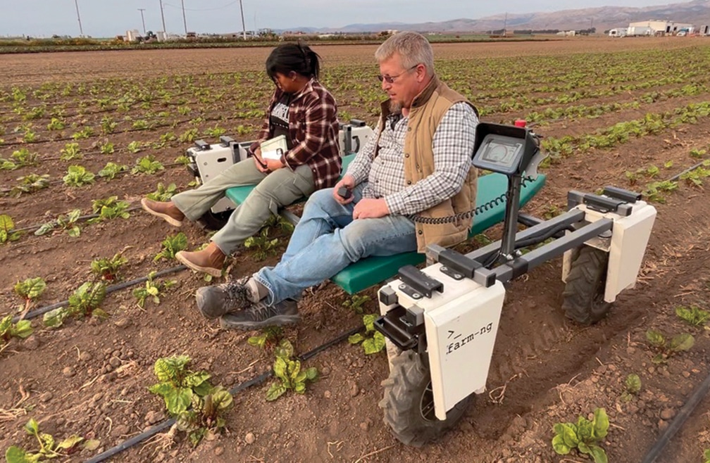 a woman and a man on farm equipment