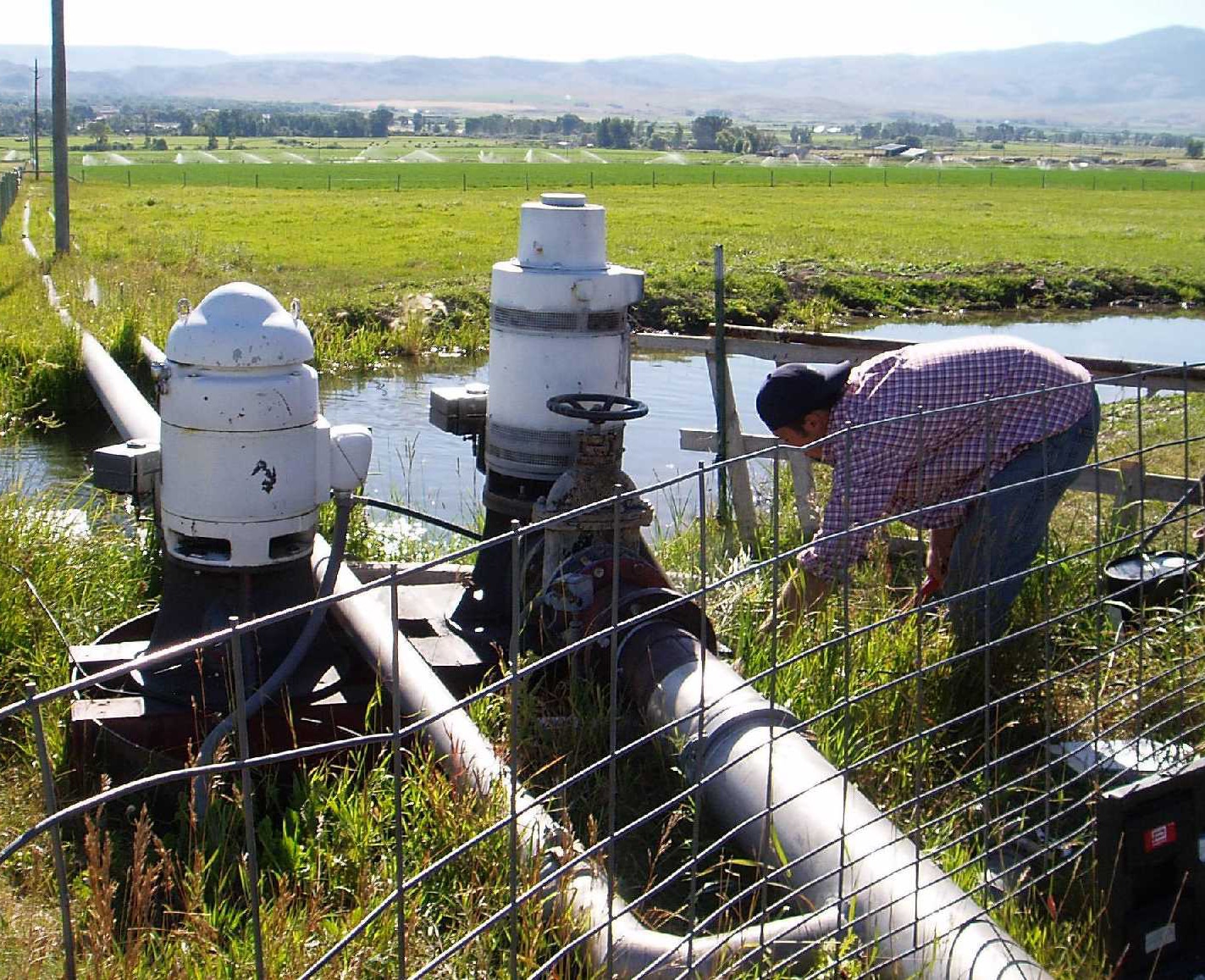 man working on irrigation pipe