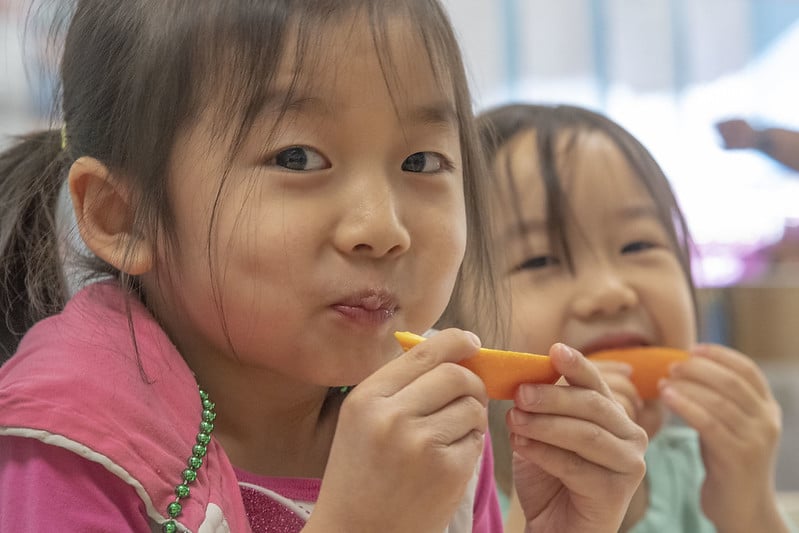 two children eating fruit