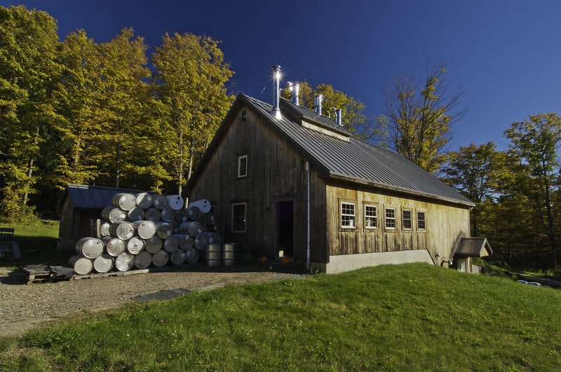sugarhouse and barrels at maple syrup operation in Vermont