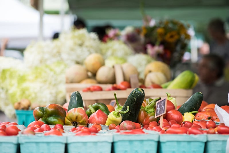 vegetables in containers displayed at a farmers market