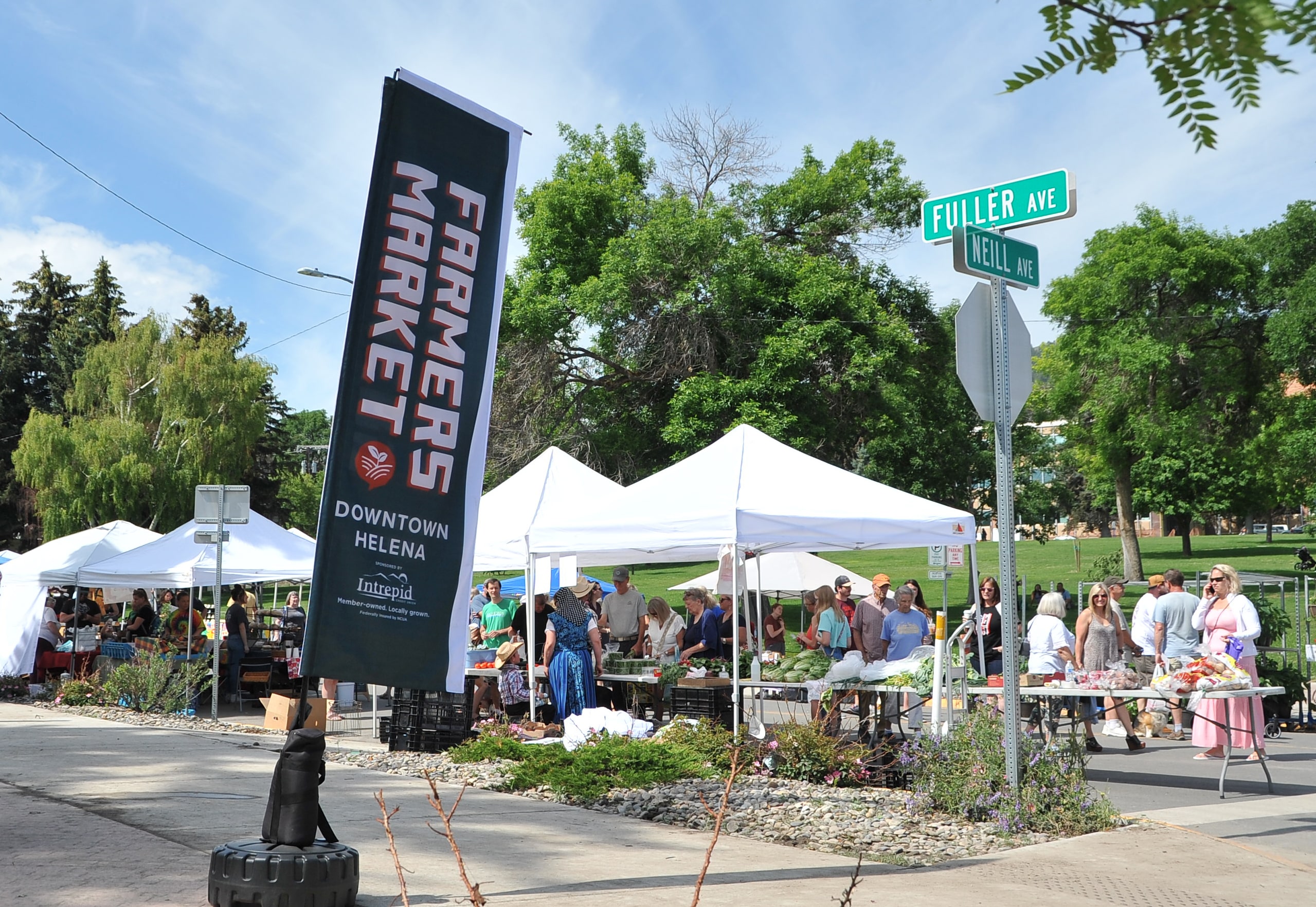 farmers market banner in front of market tents