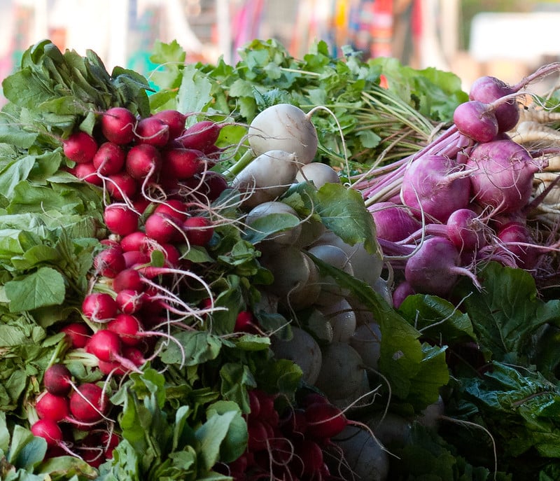 bunched vegetables stacked in market display