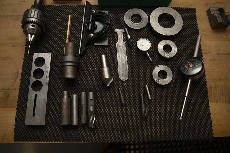 tools and parts set out on a mat on a wooden table