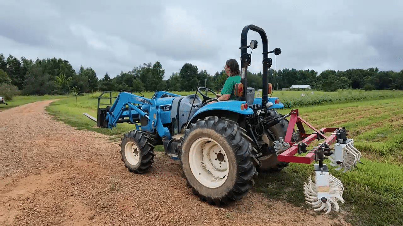 Person driving a blue tractor