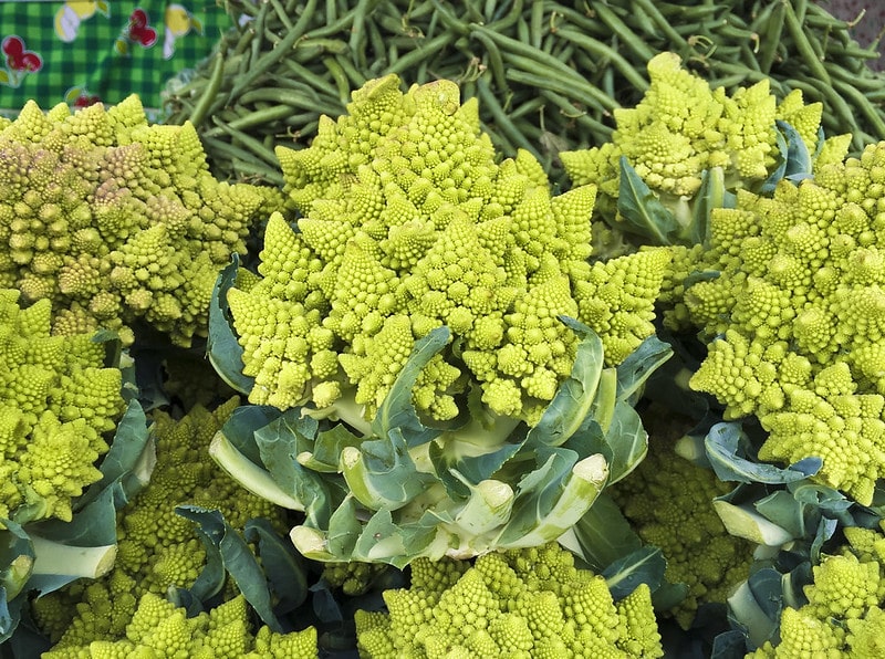stacked heads of Romanesco and green beans